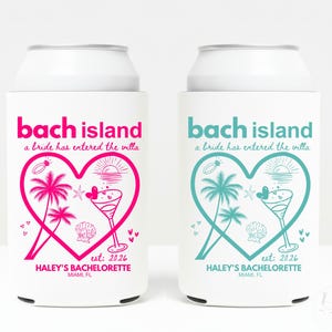 May include: Two white can coolers with the text "bach island" in pink and teal. Each cooler features a heart-shaped design with palm trees, a cocktail, and the text "a bride has entered the villa". The bottom text reads "HALEY'S BACHELORETTE, MIAMI, FL".