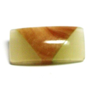 May include: A rectangular, light green and brown, decorative, polished stone with a triangular pattern.