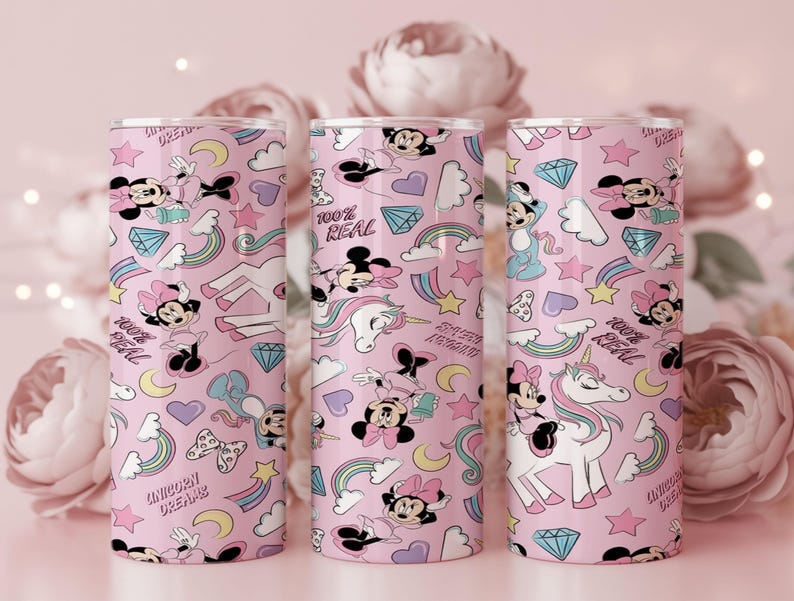 May include: Three pink tumblers with a repeating pattern of Minnie Mouse, unicorns, rainbows, stars, and diamonds. The text "100% REAL" and "UNICORN DREAMS" are also featured on the tumblers. The tumblers are cylindrical and appear to be made of metal.