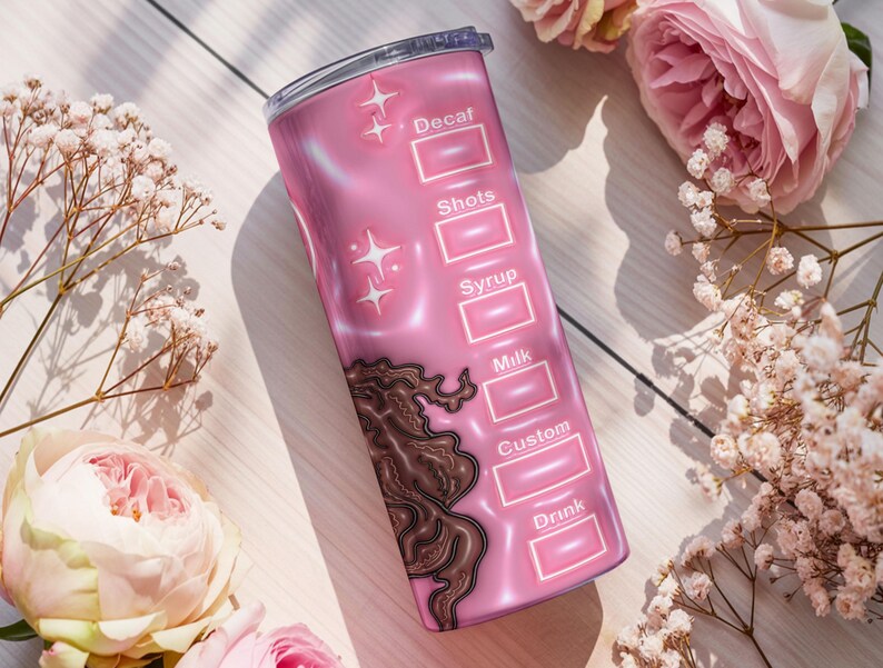 May include: A pink insulated travel mug with a coffee order chart design. The mug has sections for "Decaf," "Shots," "Syrup," "Milk," "Custom," and "Drink." Decorative elements include star shapes and a brown swirl design. Pink flowers surround the mug.