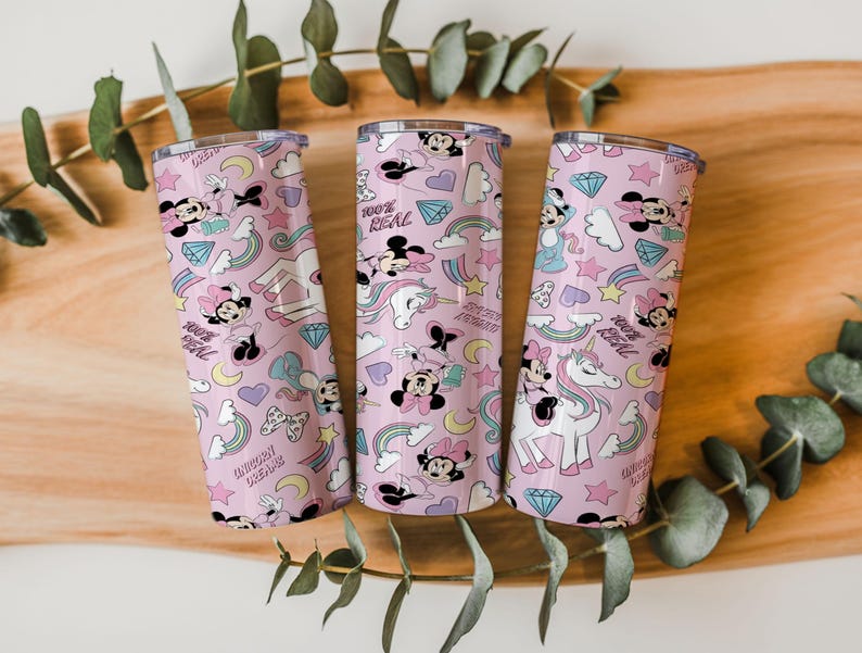 May include: Three pink insulated tumblers with a repeating pattern of Minnie Mouse, unicorns, rainbows, diamonds, and stars. The text "100% REAL" and "Unicorn Dreams" are also featured on the tumblers.