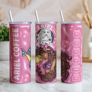 May include: Pink insulated tumbler with a white straw. The tumbler features the text "ARIEL COFFEE" and illustrations of Ariel and Flounder. The design includes a mermaid and coffee cup graphic, with a drink customization chart.