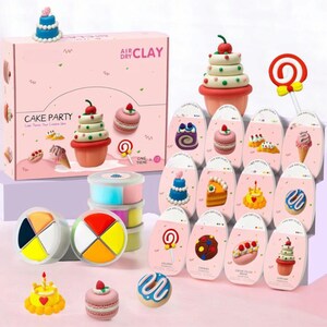 May include: A pink box set labeled "Air Dry Clay" with a "Cake Party" theme. The set includes various clay cake and dessert designs, including cupcakes, macarons, and a lollipop. Additional clay containers and pre-made clay desserts are also visible.