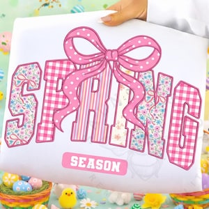 May include: A distressed white wooden sign displaying the word "Welcome" in a handwritten font. The sign has a rustic appearance with a floral design in the corner. The background is a blurred image of a wooden surface.