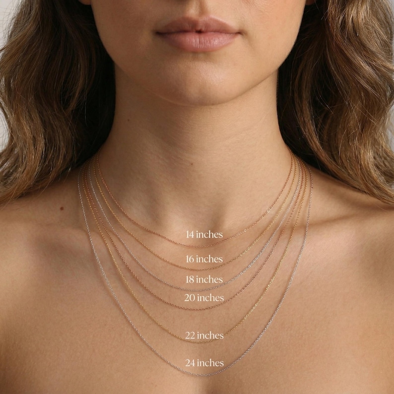 May include: A selection of delicate gold necklaces of varying lengths, ranging from 14 to 24 inches. Each chain is displayed against a person's neck, with the length of each necklace clearly labeled in inches.