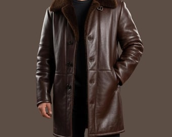 May include: A brown leather coat with a shearling collar and lining. The coat has a button-up front, long sleeves, and pockets. The coat is knee-length and appears to be made of high-quality leather.