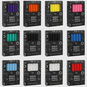 May include: A collection of twelve boxes of "Magic Spell Candles", each with a set of small, coloured candles. The black boxes feature white text and occult illustrations. Colours include purple, orange, yellow, pink, teal, black, blue, white, and red.