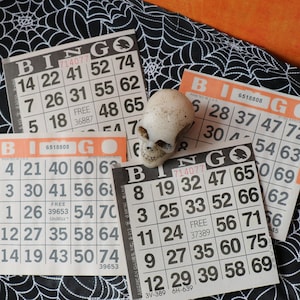4 tarjetas de bingo vintage de papel naranja y negro