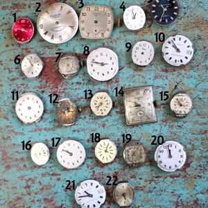 May include: A collection of 22 vintage wristwatches in various styles and colours, including silver, gold, and black. The watches are arranged in a grid pattern on a turquoise blue surface. Some of the watches have Roman numeral markings, while others have Arabic numeral markings.