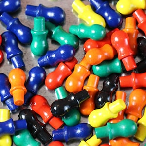May include: A collection of colorful wooden knobs with different shapes and sizes. The knobs are painted in various colors, including red, blue, green, yellow, orange, and black.