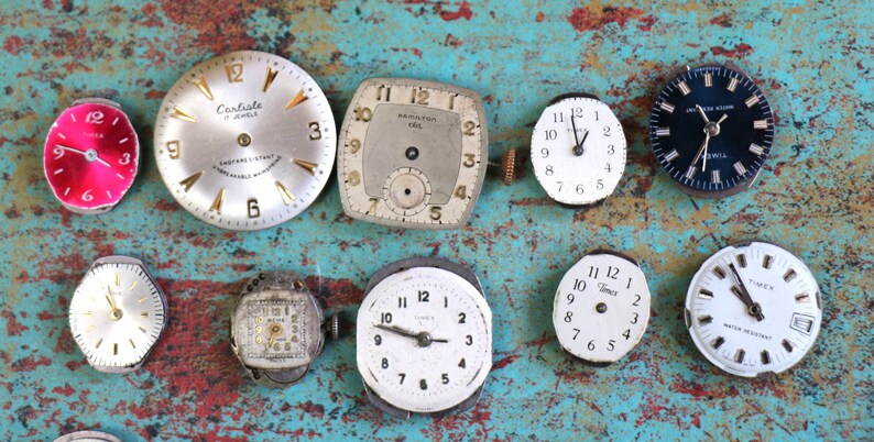 May include: A collection of ten vintage wristwatches, featuring a variety of styles and designs. The watches have round, square, and rectangular faces with different coloured dials and hands. Some of the watches have Roman numeral markings, while others have Arabic numeral markings.