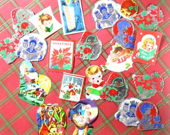 May include: A collection of vintage Christmas stickers featuring various holiday themes, including a church, a nativity scene, carolers, a candle, and a poinsettia. The stickers are printed on colorful paper with gold foil accents.