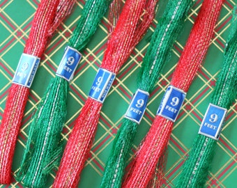 May include: Six spools of red and green metallic ribbon with gold thread. Each spool is labeled "9 feet".
