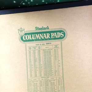 May include: A brown paper pad with green text that reads "Standard Columnar Pads 50 Leaves to the Pad This is No. 6905". The pad has a chart with numbers and measurements for different sizes of columnar pads.