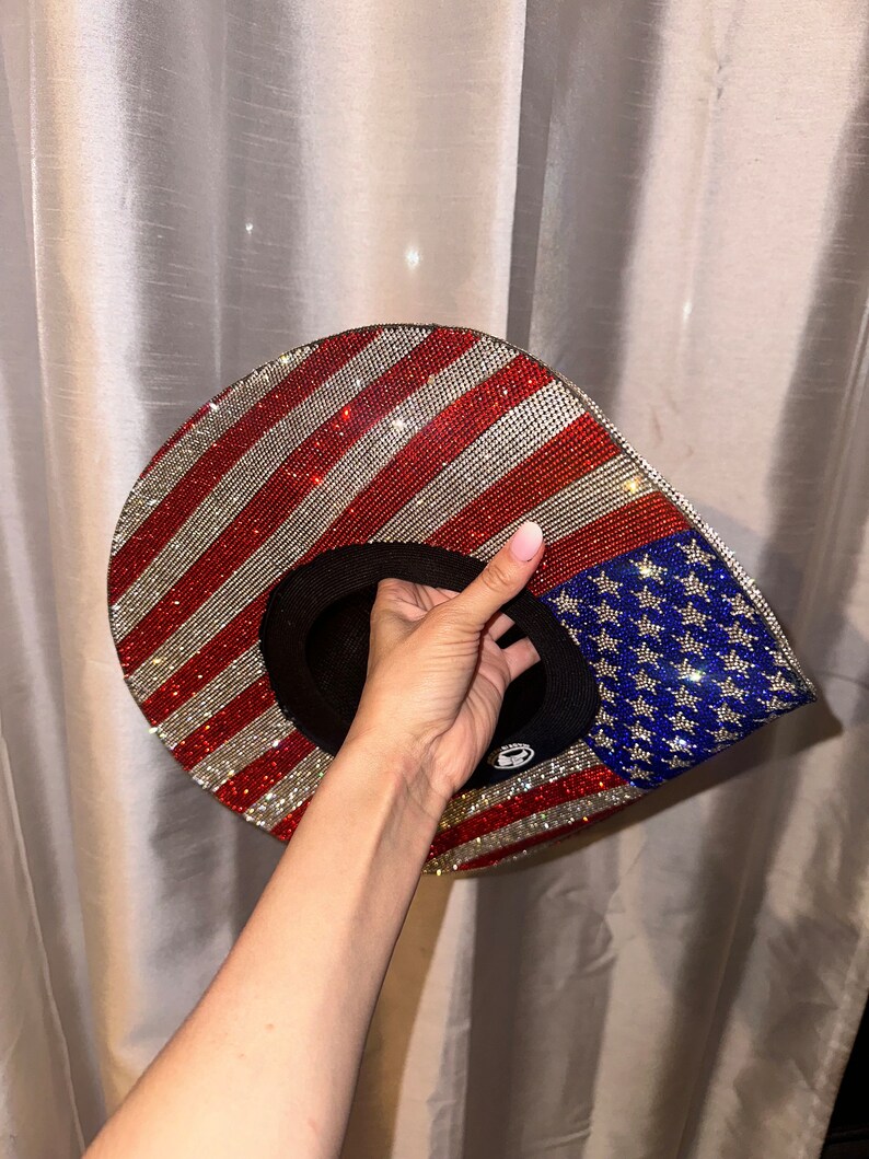 K&ouml;nnte beinhalten: Ein Hut mit amerikanischer Flaggenmusterung in Rot, Wei&szlig; und Blau, der mit Strasssteinen besetzt ist.