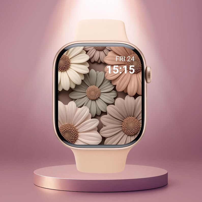 May include: A light peach smartwatch with a floral display featuring white, sage green, and peach-colored flowers. The watch face displays the date and time: FRI 24, 15:15. The watch is on a matching peach-colored stand.