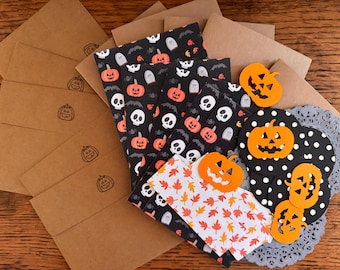 May include: A collection of Halloween-themed stationery and decorations. Includes brown envelopes with pumpkin stamps, patterned papers with pumpkins, skulls, and leaves, and orange pumpkin cutouts. A festive assortment for the spooky season.
