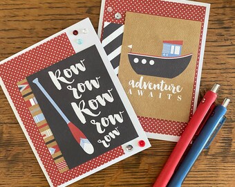 May include: Two handmade greeting cards with red and white polka dot backgrounds. One card features a black and white illustration of an oar with the text "Row row row row". The other card features a brown background with a black and white illustration of a boat and the text "Adventure awaits".