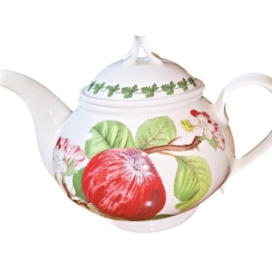 May include: White ceramic teapot with a lid, spout, and handle. The teapot is decorated with a red apple, green leaves, and white blossoms. A green vine design encircles the lid.