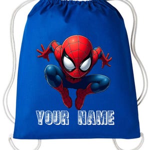 May include: A blue drawstring bag featuring a graphic of Spider-Man in a crouching pose. The superhero is depicted in his classic red and blue suit. The text "YOUR NAME" is printed in white block letters at the bottom of the bag.
