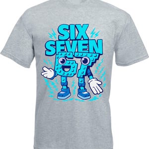 May include: A gray t-shirt featuring the words "SIX SEVEN" in large, light blue block letters. Below the words are the numbers "67" designed as cartoon characters with arms, legs, and smiling faces. Blue lightning bolts surround the design.