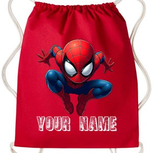 May include: Red drawstring backpack featuring a graphic of Spider-Man in a crouching pose. The superhero is depicted in his classic red and blue suit. The text "YOUR NAME" is printed in white across the bottom of the bag.