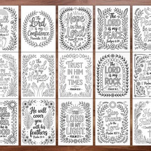 May include: A collection of fifteen black and white inspirational cards with floral and leaf borders. Each card features a different Bible verse, such as "Walk by Faith" and "The Lord is my Shepherd." The cards are designed for coloring.