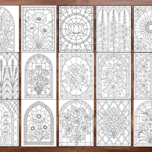 May include: A collection of fifteen black and white stained glass designs featuring floral and geometric patterns. Designs include irises, poppies, a lotus flower, sunflowers, lavender, roses, and other flowers. Each design is framed within a rectangular or arched border.
