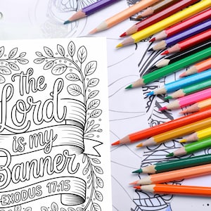 May include: A coloring page with the text "The Lord is my Banner Exodus 17:15" surrounded by a floral design. A collection of colored pencils in various colors are scattered across the page, ready for use.