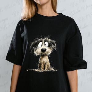 May include: Black t-shirt featuring a cartoon illustration of a dog with big eyes and shaggy fur. The dog is depicted in shades of black, white, and brown. The shirt is a casual style, suitable for everyday wear.