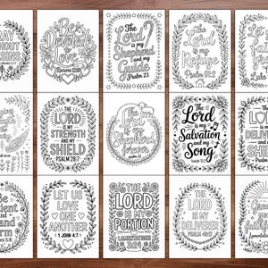 May include: A collection of fifteen black and white coloring pages with inspirational quotes from the Bible. Each card features a different verse, surrounded by floral and leaf wreaths. The text is in a variety of fonts.