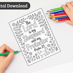May include: A black and white coloring page with the text "The Lord is my Shepherd and my Protector - Psalm 23" surrounded by floral and leaf designs. A hand holds a green pencil, and another holds colored pencils.