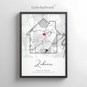 May include: Framed black and white map print featuring a house outline with a city map inside. A red heart marks a location. The word "Zuhause" is written in cursive, with additional text below.