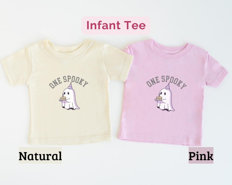 May include: Two short-sleeve infant tees in natural and pink colors. Each shirt features a graphic of a white ghost wearing a purple party hat and holding a birthday cake, with the text "ONE SPOOKY" arched above the ghost in gray lettering.