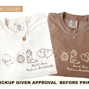 May include: Two Comfort Colors t-shirts, one white and one brown, with a Desert Disco design. The design includes a cowboy hat, disco ball, cowboy boot, and intertwined hearts. The text "Desert Disco Meghan's Bachelorette" is printed below the graphics.