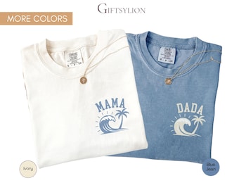 May include: Two t-shirts, one ivory and one blue jean, with the word "MAMA" and "DADA" printed on them. Each shirt has a wave and palm tree graphic. Gold necklaces with round pendants are draped on the shirts. The brand name "GIFTSYLION" is at the top.