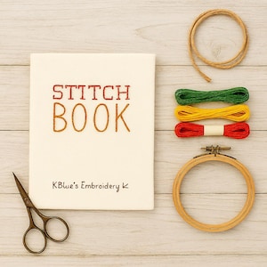 Peut inclure: Un "Stitch Book" crème avec des lettres brodées rouges et orange, accompagné de fil à broder vert, jaune et rouge, d'un cercle à broder en bois, de ciseaux et de ficelle. Le texte "KBlue's Embroidery" est également visible.