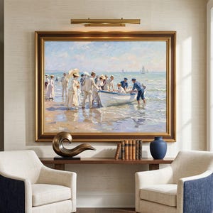 May include: A room interior with two cream armchairs with navy blue panels. A large framed painting of a beach scene hangs above a wooden console table with decorative items. A patterned rug and a window complete the room.