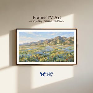 Puede incluir: Una pintura de paisaje enmarcada de una cordillera y un campo de flores silvestres. La obra de arte se exhibe en una pared y presenta el texto "Frame TV Art" y "4K Quality | 3840x2160 Pixels". La pintura tiene un marco marrón.