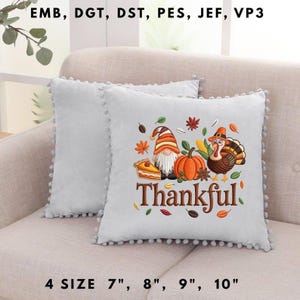 May include: Two light gray decorative throw pillows with a pom-pom trim. One pillow features an embroidered Thanksgiving design with a gnome, pumpkin, turkey, and the word "Thankful". Available in 7", 8", 9", and 10" sizes.