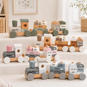 May include: Three wooden toy trains featuring natural wood bases and wheels. Each train is personalized with a name and includes stacked blocks displaying birth details such as date, year, weight in grams, time, and length in centimeters.