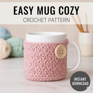 May include: A white mug with a pink crocheted cozy and a wooden button closure. The text "EASY MUG COZY CROCHET PATTERN" is at the top. The words "INSTANT DOWNLOAD" are in a circle at the bottom.