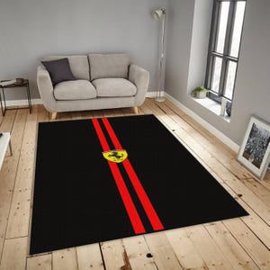 May include: A rectangular area rug featuring a solid black background with two vertical red stripes running down the center. A yellow shield-shaped emblem with a black prancing horse silhouette is centered on the red stripes.