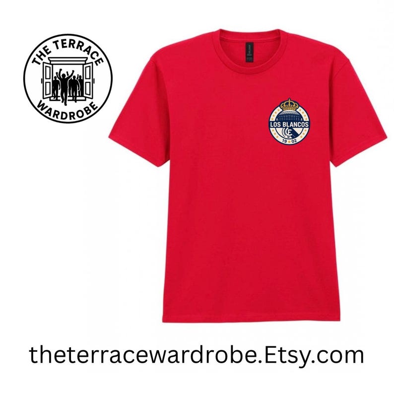 May include: A red t-shirt with a crew neck and short sleeves. The shirt features a small emblem on the left chest with the text "LOS BLANCOS" and "1902". The Terrace Wardrobe logo is on the left side. The website address is at the bottom.