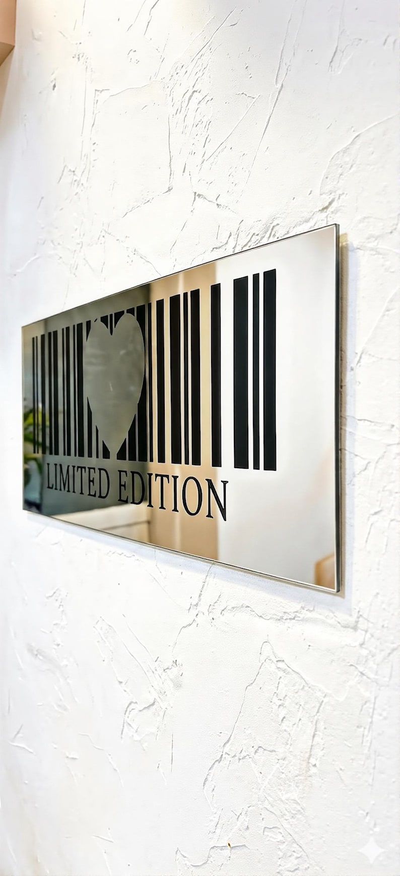 May include: A rectangular mirror with a silver frame. The mirror features a barcode design with a heart-shaped cutout in the center. The words "LIMITED EDITION" are printed in black below the barcode.