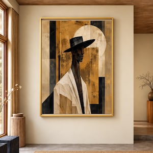 Può includere: Una stampa d'arte da parete incorniciata raffigurante una figura stilizzata che indossa un cappello nero a tesa larga e un indumento bianco. La composizione utilizza forme geometriche in tonalità oro, marrone e nero, con un cerchio.