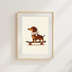 May include: A framed print featuring a brown dachshund wearing a scarf, riding a skateboard. The dog has a long body and short legs. The skateboard is black with orange wheels. The background is a light cream color.