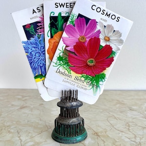 May include: A white ceramic mug with a black handle and the text "But First, Coffee" in a handwritten style. The mug is on a white surface. The mug is approximately 4 inches tall.