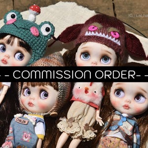 May include: A collection of custom dolls with large eyes, wearing various handmade hats and outfits. The dolls have detailed facial features and are arranged closely together. The image includes the text "-- COMMISSION ORDER --".