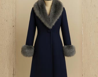 May include: A navy blue coat with a gray faux fur collar and cuffs. The coat has a single button closure and a classic, tailored design. The coat is displayed on a mannequin.